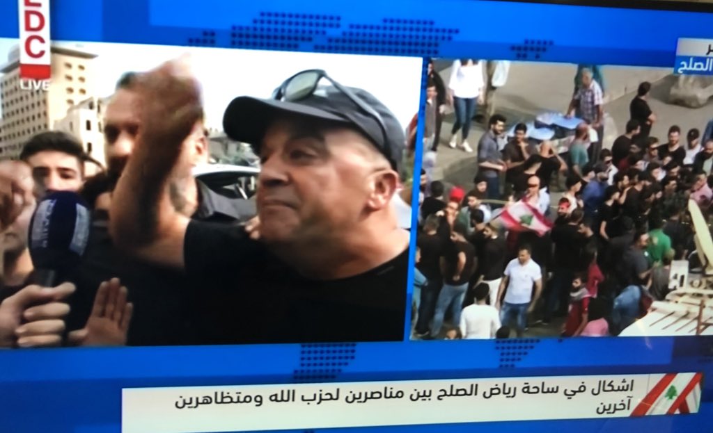 Fist fights break out between group of Nasrallah supporters and other protestors. They say no one is allowed to curse the Sayed or they will crush their hearts Some threaten media and say stop filming, riot police intervene