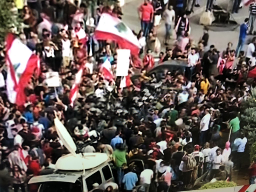 Fist fights break out between group of Nasrallah supporters and other protestors. They say no one is allowed to curse the Sayed or they will crush their hearts Some threaten media and say stop filming, riot police intervene