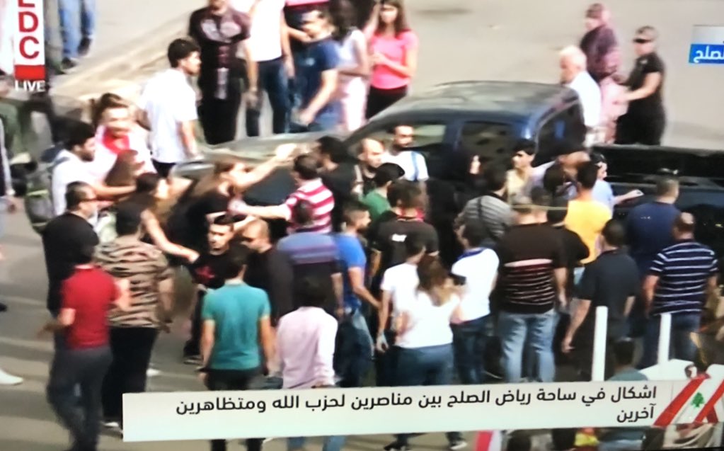 Fist fights break out between group of Nasrallah supporters and other protestors. They say no one is allowed to curse the Sayed or they will crush their hearts Some threaten media and say stop filming, riot police intervene