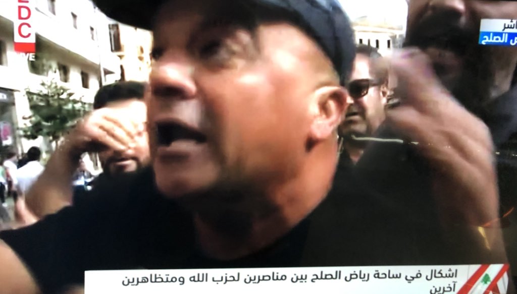 Fist fights break out between group of Nasrallah supporters and other protestors. They say no one is allowed to curse the Sayed or they will crush their hearts Some threaten media and say stop filming, riot police intervene