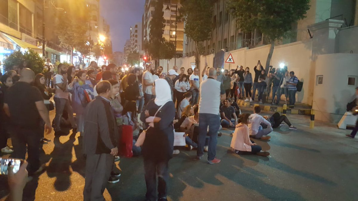 Protesters gather and block road in front of Beirut's Helou police station where activist Salim Ghadban is still being detained.  
