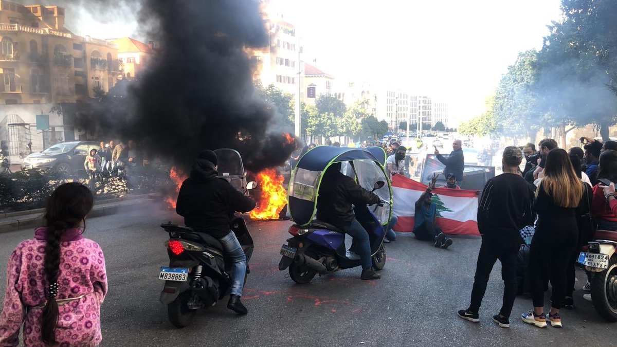 Demonstrators set tires on fire at Ring Bridge in Beirut