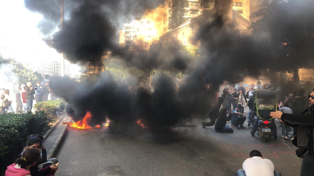 Demonstrators set tires on fire at Ring Bridge in Beirut