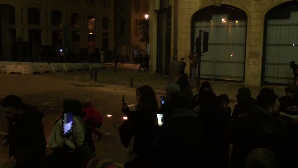 Downtown Beirut in front of Parliament: people are starting to throw firecrackers and Molotov cocktails at the police line