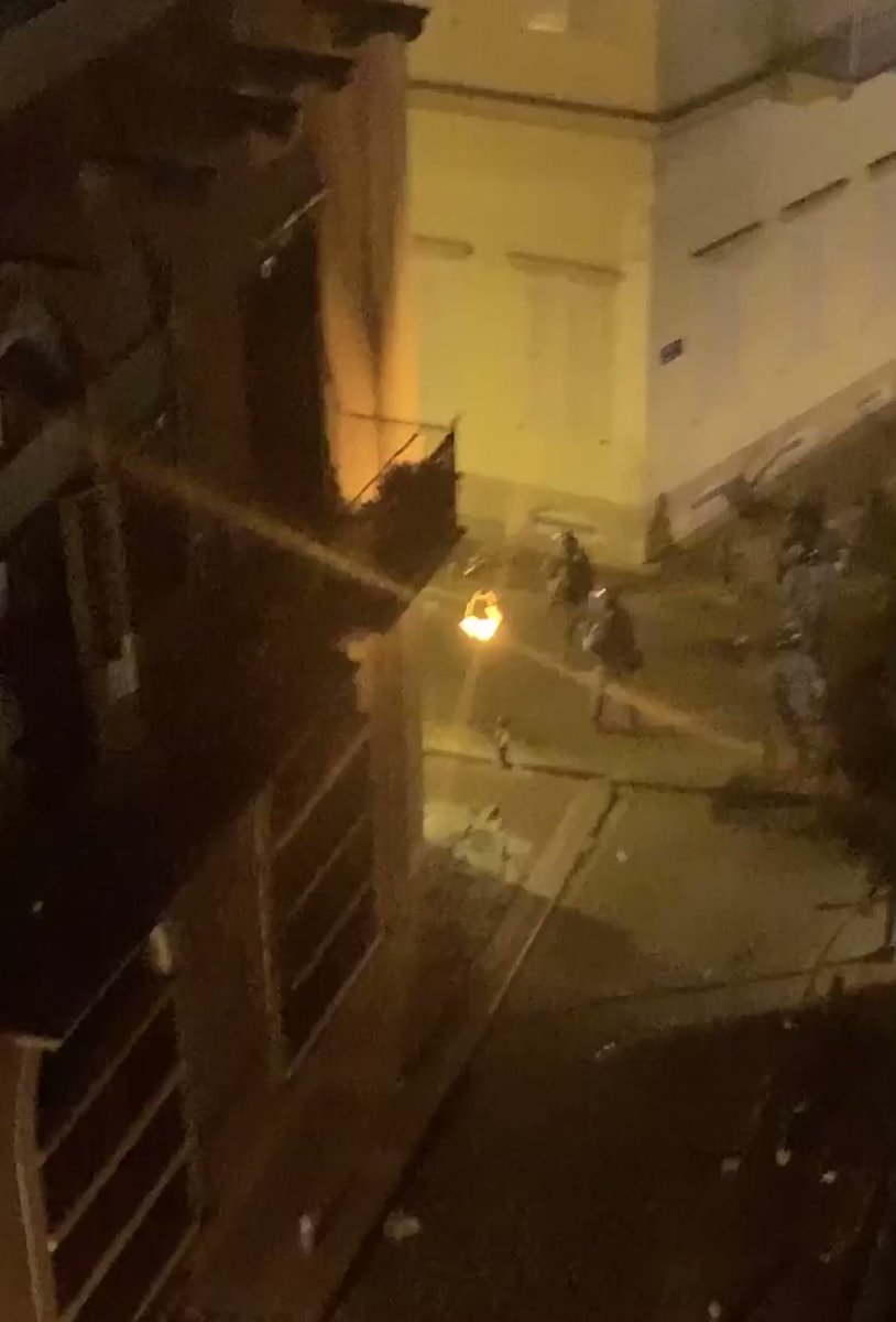 The Internal Security Forces fire tear gas canisters at demonstrators from inside the destroyed residential neighborhoods of Beirut