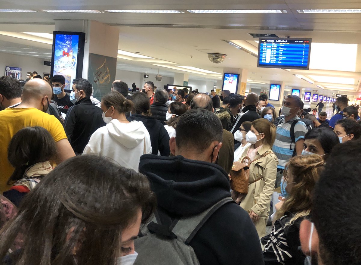 Hundreds of people jammed together waiting for the compulsory covid test on arrival at Beirut airport. The idea is to stop people from spreading covid 