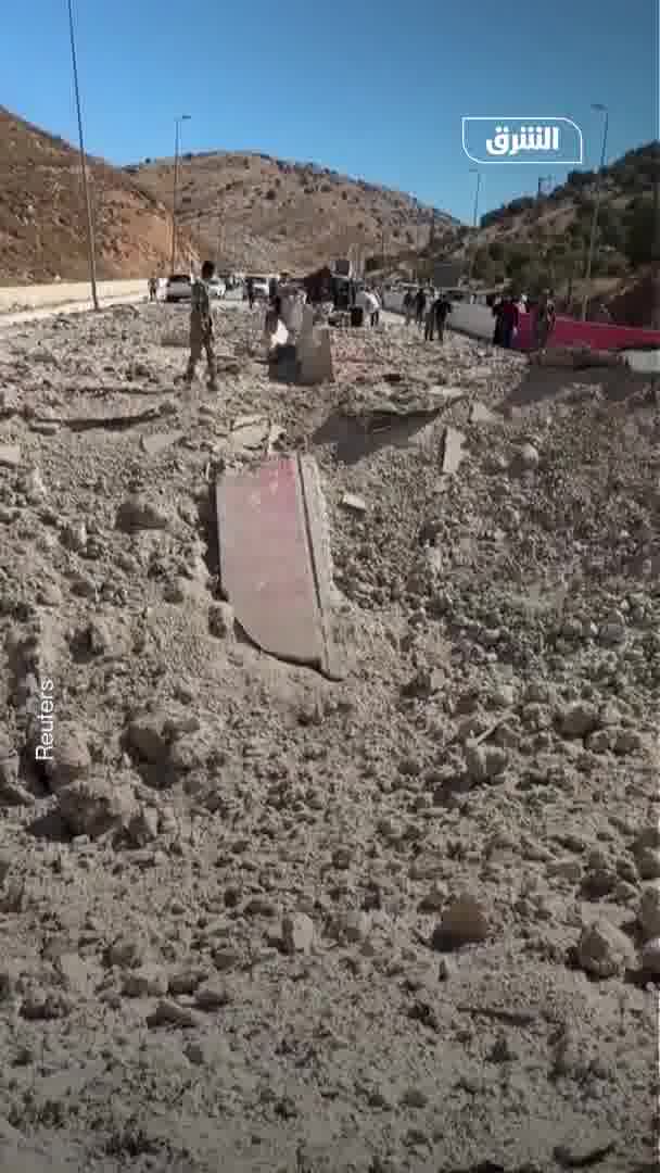 Displaced people from Lebanon head to the Al-Masnaa border crossing with Syria on foot after an Israeli raid cut off the road leading to it