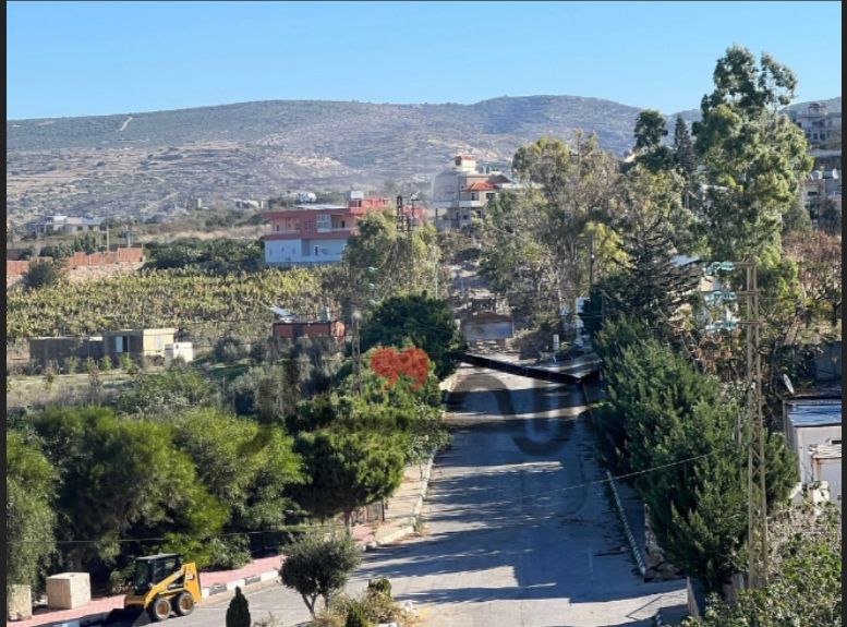 Israeli bulldozers move at the western entrance to the town of Naqoura, opposite the UNIFIL headquarters