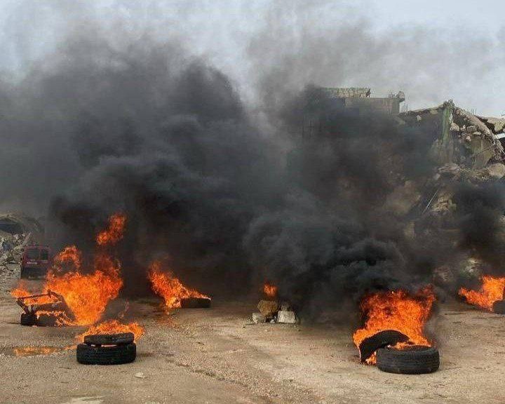 Residents of Kafrkila set tires alight to protest the plight of refugees and the reconstruction of the country