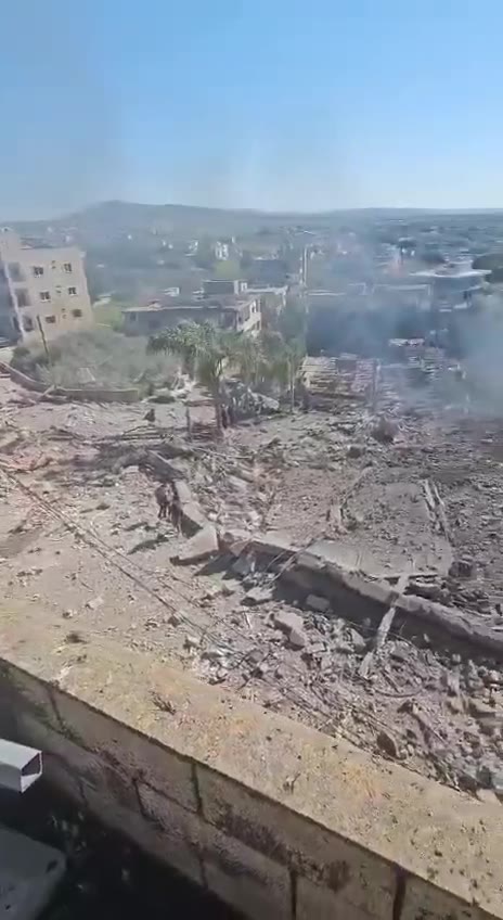 The aftermath of the bombing in the town of Kafr Tebnit in southern Lebanon following an airstrike.