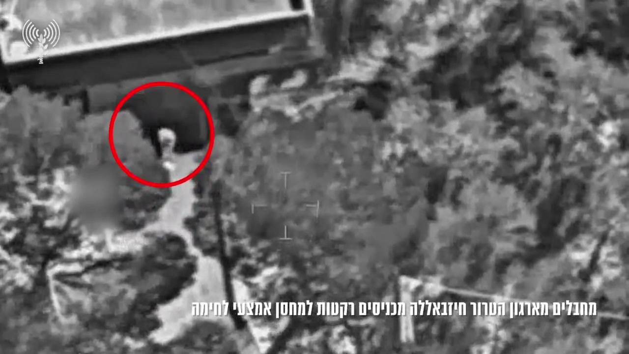 The Israeli army publishes footage showing what it says are Hezbollah operatives loading rockets into a weapons depot in southern Lebanon town of Mjadel yesterday, and a subsequent airstrike on the site