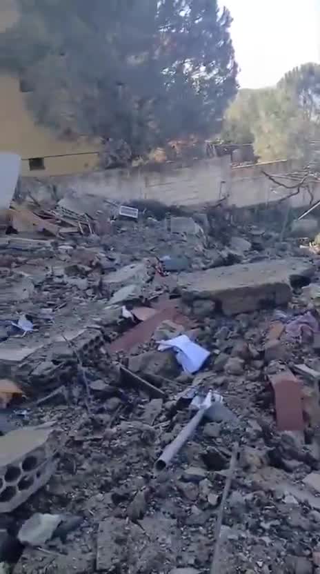 Destruction caused by the airstrike that targeted a house in the town of Al-Duwayr