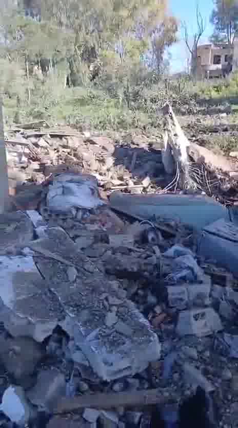 Destruction caused by the airstrike that targeted a house in the town of Al-Duwayr