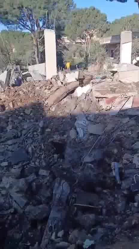 Destruction caused by the airstrike that targeted a house in the town of Al-Duwayr