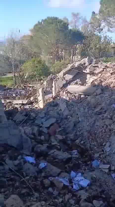 Destruction caused by the airstrike that targeted a house in the town of Al-Duwayr